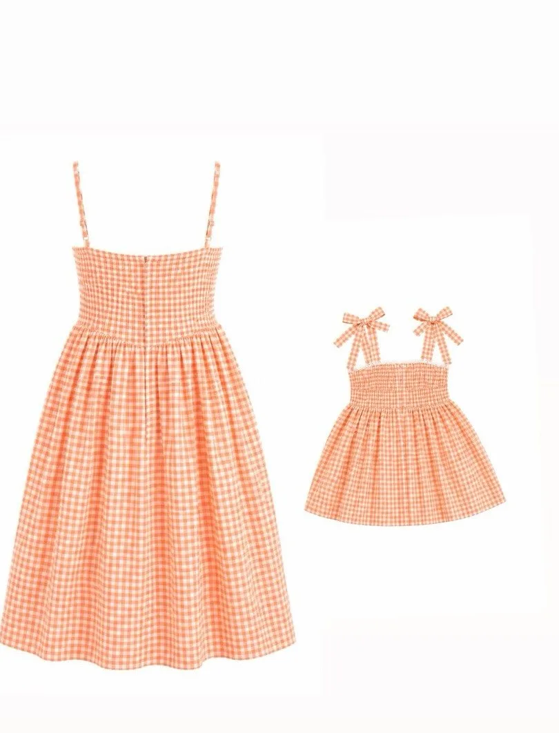 Apricot gingham mom and daughter dresses, flat lay